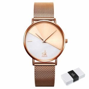 Ženski ručni sat SK Shengke DuoTone Metal Rose Gold s dvobojnim brojčanikom i ružičasto-zlatnim metalnim remenom, prikazan s kutijicom.